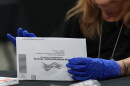 FILE — An election worker sorts vote-by-mail ballots at the Miami-Dade County Supervisor of Elections Office for the Florida primary election in Doral, Fla., Aug. 18, 2026.