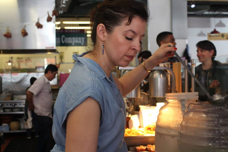 Dominica Rice serves drinks at her restaurant Cosecha as Rene Sanchez and Panfila Ceja work behind her and customers wait in line on March 9, 2017. Rice has already repaid her SBA loan. (Farida Jhabvala Romero/KQED)