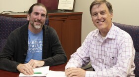 :  Faculty Association Lead Sean Colcleasure and Board Chair Gregg Chadwick sign the new 3-year agreement.