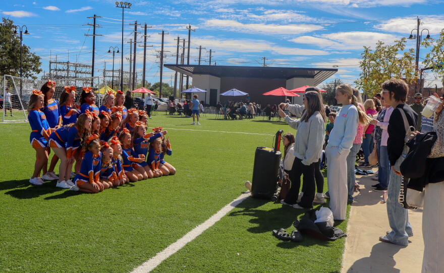 Infinity tumbling and cheer poses for a group picture. Photo by Emma Coats.
