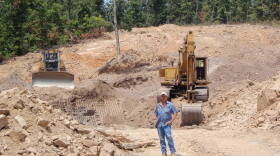 Jimmy Watson stands in front of what will be the opening to the mine.