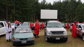 Port Townsend High School seniors stepped outside their vehicles to receive their diplomas during the 2020 graduation ceremony held at the local drive-in movie theater. (Tom Banse/Northwest News Network)