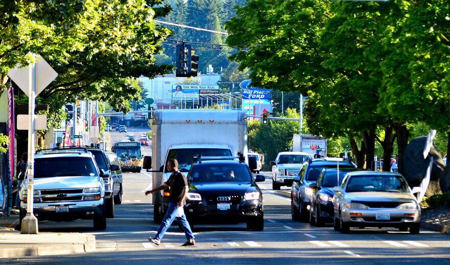 A pedestrian crosses Lake City Way near Northeast 125th Street in Seattle's City Council District 5.