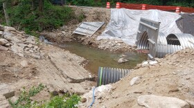 A damaged culvert is undergoing repairs near Bearwallow Mountain Road.