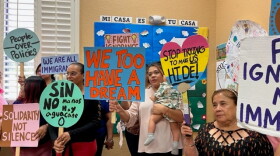 Women and children protest a new immigration law at Hope Community Center.