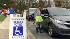 Election worker assisting voters with curbside voting