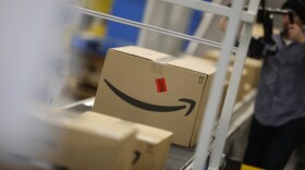 Boxes move down a conveyor belt during a tour of the Amazon fulfillment center Thursday, May 3, 2018, in Aurora, Colo. (David Zalubowski/AP)