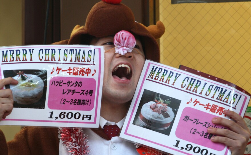 A man in a reindeer costume hawks Christmas cake outside a bakery in Kobe, Japan, Dec. 23, 2011.