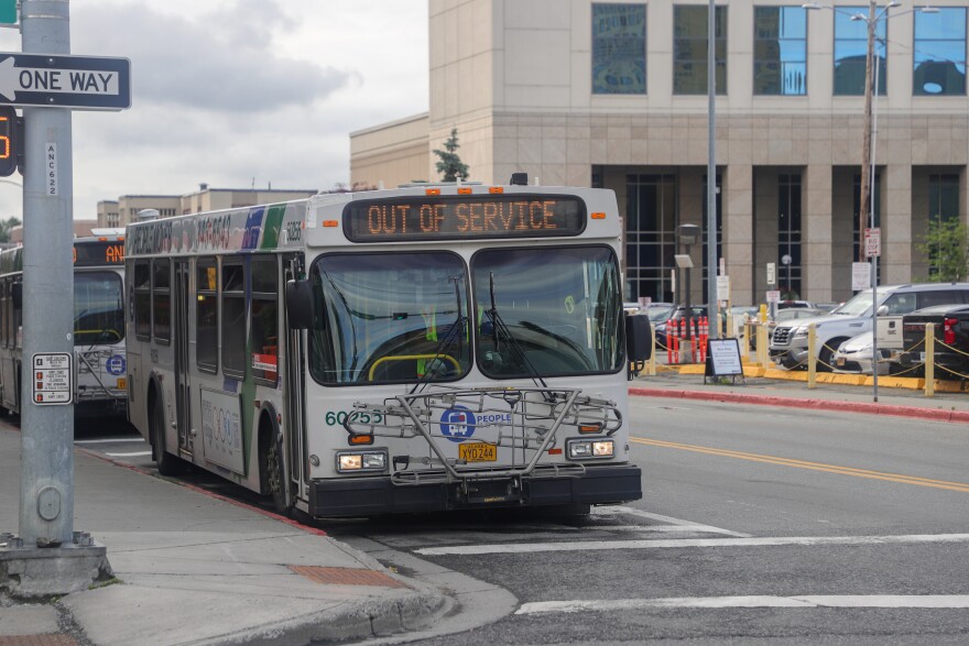 A bus at an intersection. The front screen reads "OUT OF SERVICE."