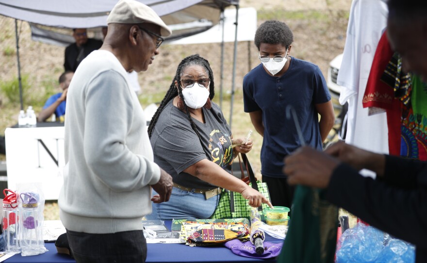 Festival shops for clothing during the 2022 Publix Tampa Bay Collard Festival in St. Petersburg, Florida, on Saturday, February 19, 2022. Photo by Octavio Jones for WUSF