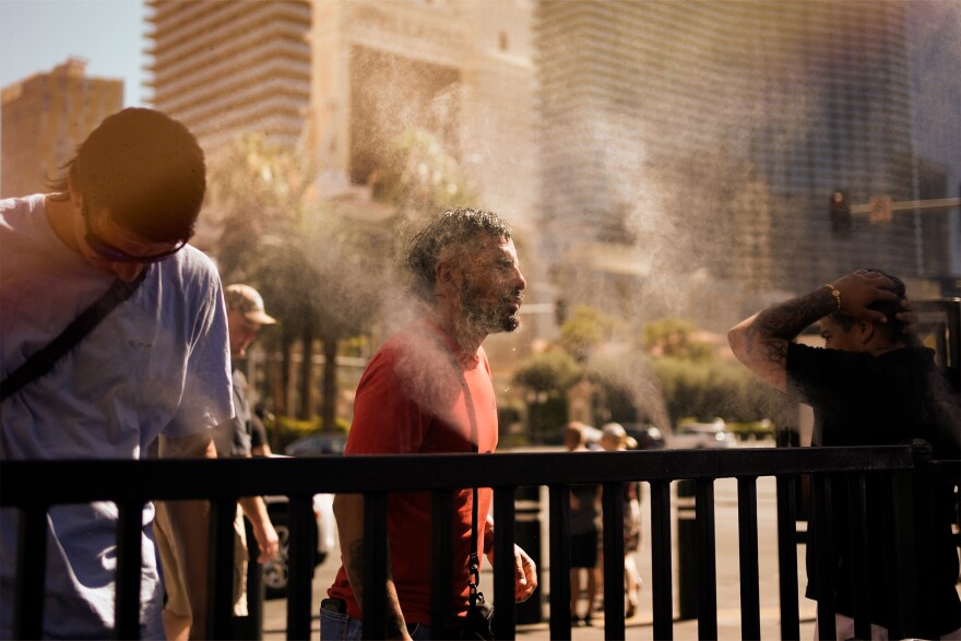 A group of people using the water misters on the Strip.