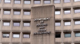 The exterior of a stone building with small windows.