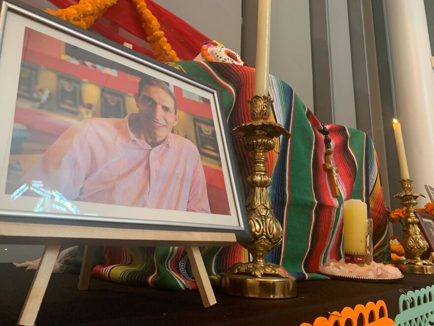 A framed photo of a man next to a candlestick