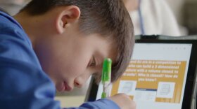 A Hilliard student completes classroom work with an iPad.