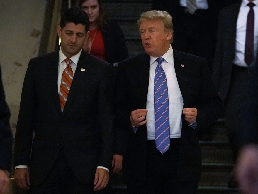 Accompanied by Speaker of the House Paul Ryan, R-Wis., President Trump arrives at a meeting with House Republicans at the U.S. Capitol Tuesday.