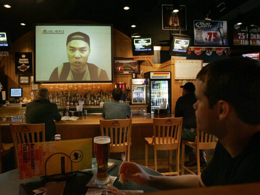 Customers watch a video of Seung-Hui Cho on the NBC Nightly News on April 18, 2007, at a local restaurant Blacksburg, Va. Between his first and second bursts of gunfire, Virginia Tech gunman Cho mailed a package to NBC that containing photos of him brandishing guns and video of him delivering an angry, profanity laced tirade. Today such rants and images are posted directly online via social media.