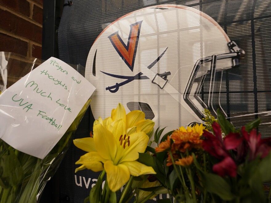 Memorial flowers and notes line walkway at Scott Stadium after three football players were killed in a shooting on the grounds of the University of Virginia Tuesday Nov. 15, 2022, in Charlottesville. Va.