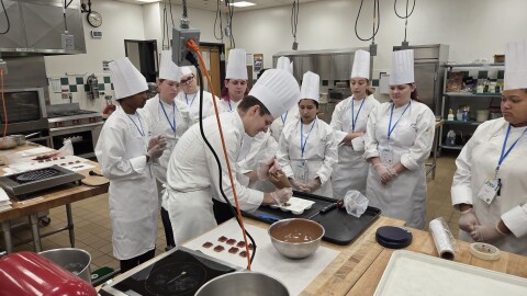 Austin Scoles teaches high schoolers how to make raspberry petit gâteaux at Johnson & Wales’ Career Explorations summer program.