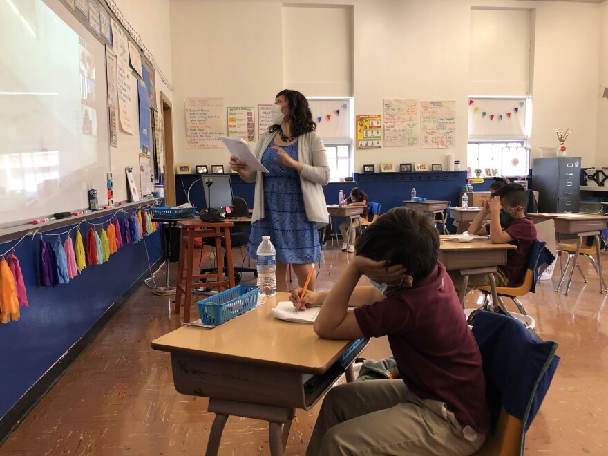 Jenny Wood's in-person students fill out worksheets as she teaches a lesson about odd and even numbers.