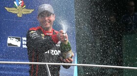 Will Power celebrates with champagne in victory lane after winning the IndyCar Grand Prix on Saturday, May 12 ,2018.