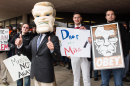 Protester wearing oversize Madigan mascot head.