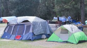 The pictured tents, resident Mike Mcneal said, belonged to Anthony Davis, who attacked another resident with an axe Saturday. A Gainesville Police Officer patrols nearby. “I’m not saying that Dignity Village is 100 percent criminals. There are some very good people that live out there, some very good people that are truly down on their luck.” But, there is a criminal element that lives out there. If it wasn’t, we would not have to put two full-time police officers out there,” GPD spokesman Officer Ben Tobias said. (Photo by Giuseppe Sabella).