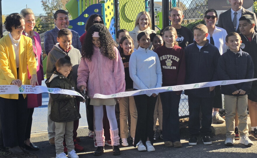 Students and school and community leaders cut the ribbon for the new playground at Whittier Elementary in South Scranton.