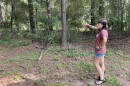 Erica Olmstead points to the property where the dirt pit just on the other side of the trees from her backyard on August 20, 2026.  "I have chronic bronchitis and lung issues from my deployment to Iraq in 2010. One of my 100% disability ratings is for bronchitis, so having all that dust and all that stuff in the air would be really, really bad for me," she said.