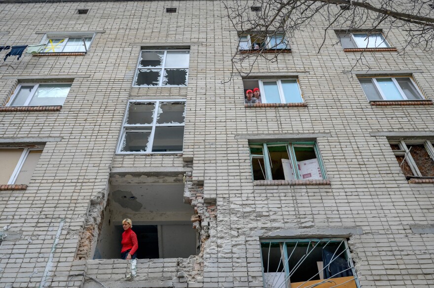 <strong>March 8:</strong> A Ukrainian woman looks out from a damaged building that was hit by a Russian mortar in Mykolaiv, about 70 miles from Odesa, in southern Ukraine.