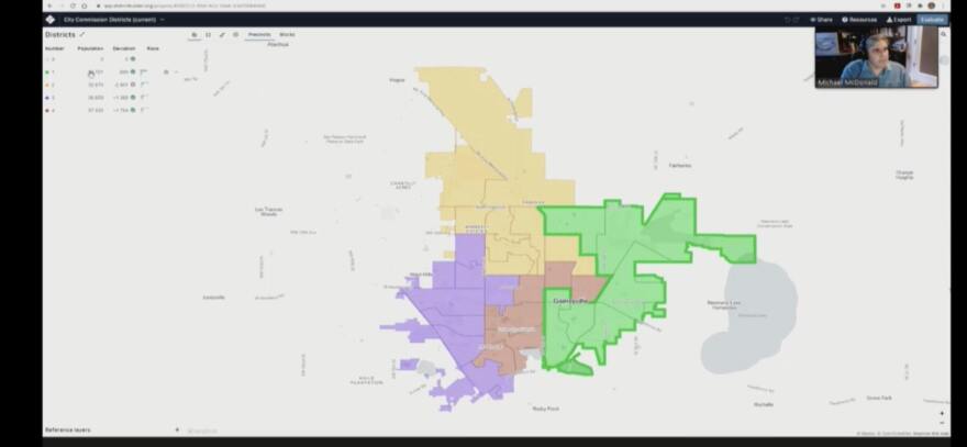 Michael McDonald shows Gainesville’s current redistricting map in DistrictBuilder. District 1 is in green, District 2 in yellow, District 3 in purple and District 4 in red. (Ezra Sheffield/WUFT News)