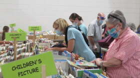 People browse through books at a Friends of the Library book sale