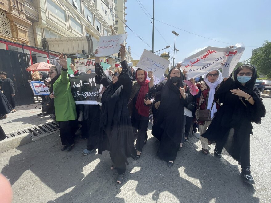 Women march down a main street in Kabul on Saturday, two days before the one-year anniversary of the Taliban takeover.