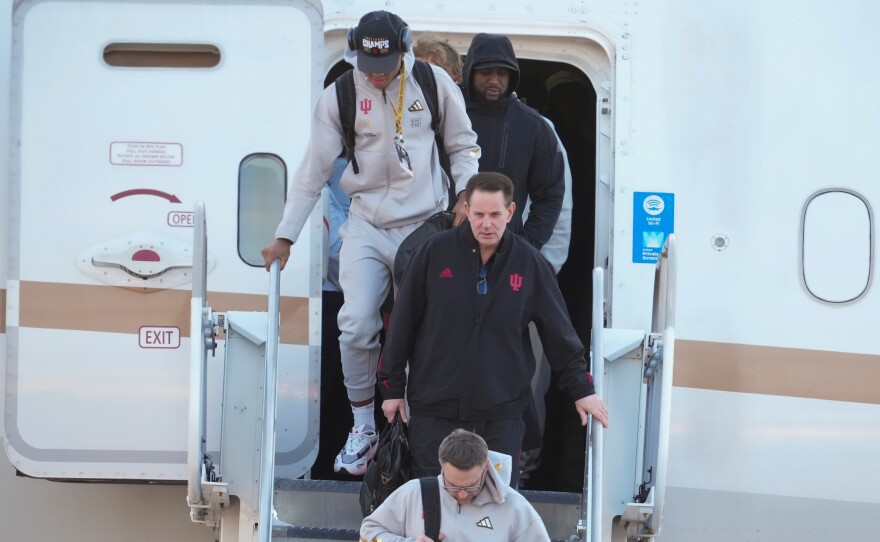 Indiana head coach Curt Cignetti, walks off the plane after the team arrived at the Indianapolis International Airport in Indianapolis, Tuesday, Jan. 20, 2026.