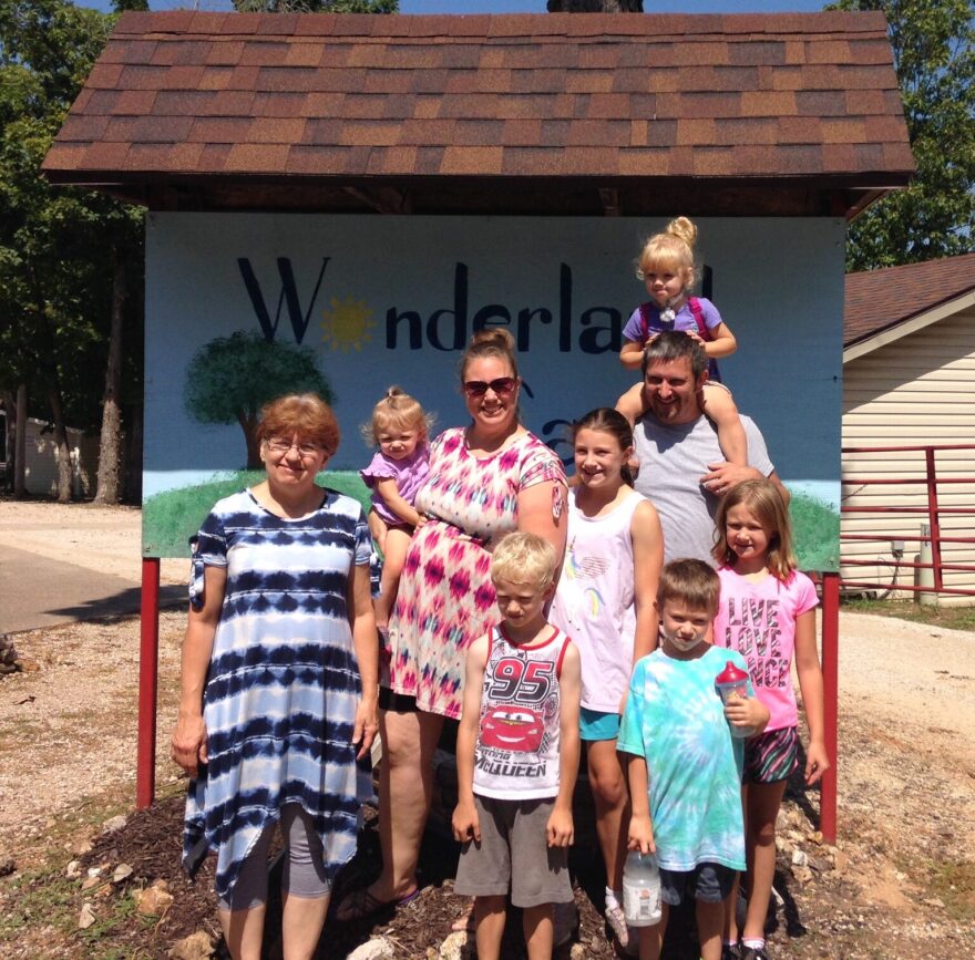 Two-year-old Isabella Bisher sits on her father’s shoulders and poses for a photo with her mom, siblings and grandma.