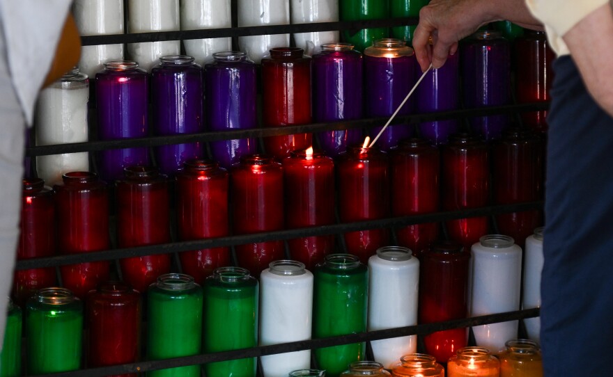 A candle is lit in the grotto of St. Ann in Scranton.