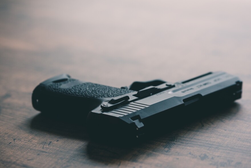 hand gun on the wooden panel