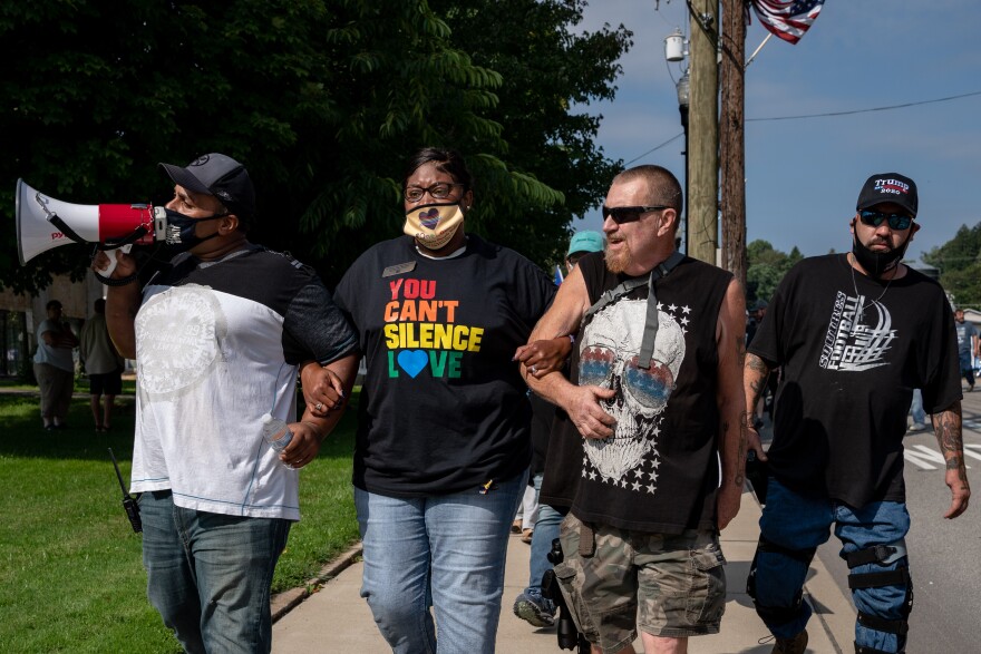 Danielle Walker arm in arm with counter protester