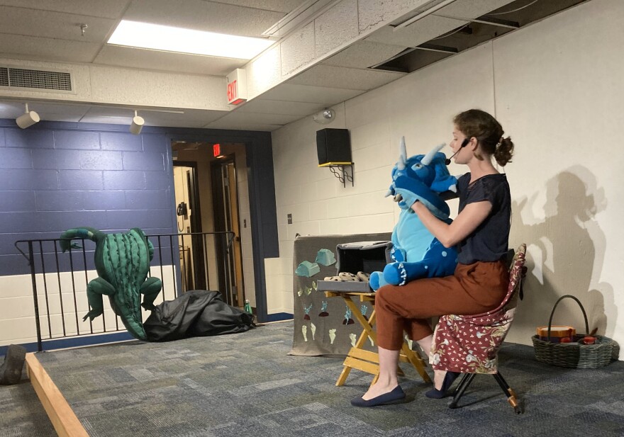 Roxy the triceratops "eats" a cookie she baked.