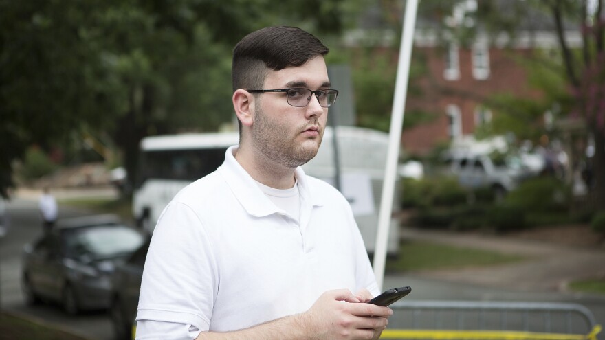 James Alex Fields Jr. stands on the sidewalk ahead of a rally in Charlottesville, Va., on Aug. 12, 2017. Later that day he is accused on ramming his car into a crowd of counterprotesters, killing Heather Heyer. On Wednesday he was charged with federal hate crimes.