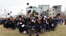 Olin College graduates throw their caps in their air at a faux-Commencement ceremony. (Leise Jones)