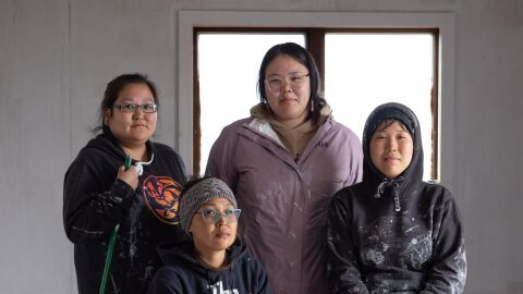 Clockwise from top: Dollie Martin, Desiree John, Nellie Manchuak and Lydia Tucker pause for a portrait while repairing a home in Kwigillingok, Alaska, on June 19, 2026. The home was damaged by flooding after ex-Typhoon Halong struck the village. All four women are from Kwigillingok and returned after initially evacuating.