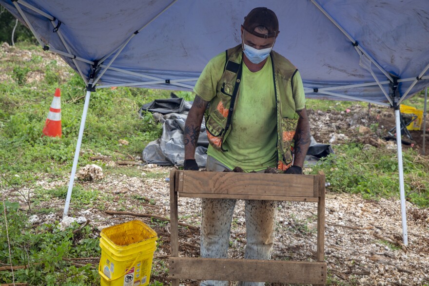 David Byerly, an archaeological technician assigned to Marine Corps Base (MCB) Camp Blaz, Guam, examines the soil for artifacts during an archaeological investigation at a construction site for the base, Oct. 14, 2020.