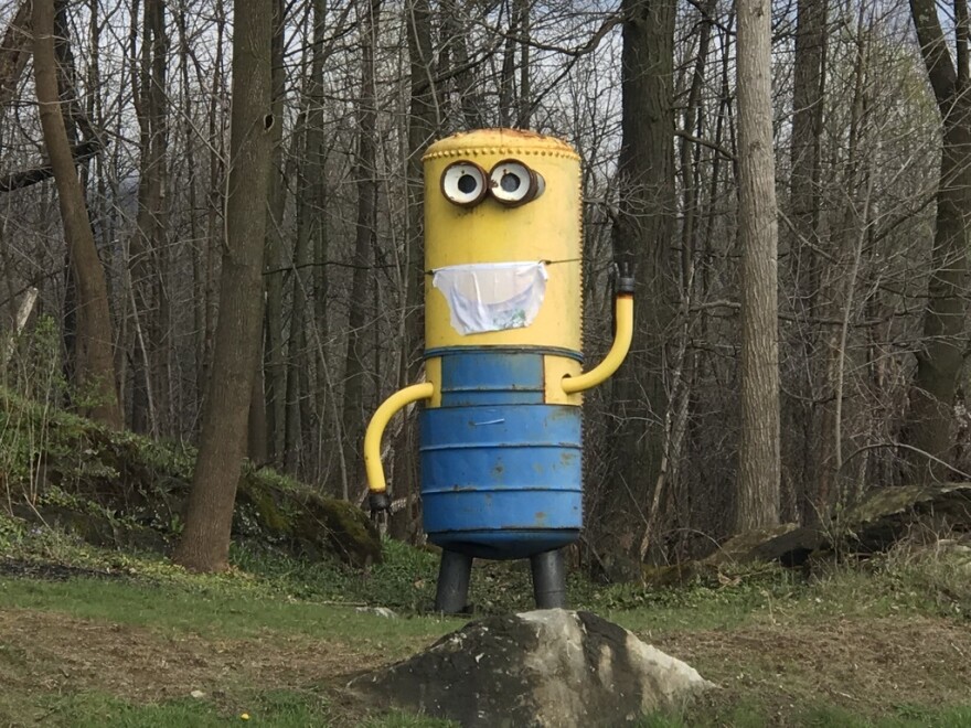 One of the sculptures along Route 7 in front of Mac Steel wears a face mask on May 1, 2020.