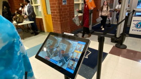 When scanners show a red box over a bag, the student goes to a nearby table to have that bag searched.
