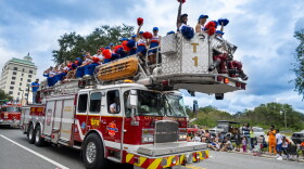 UF Cheerleaders ride on a Gainesville Fire Rescue truck during the University of Florida Homecoming parade Oct. 9, 2026, in Gainesville, Fla. (Andy Acosta/WUFT News)