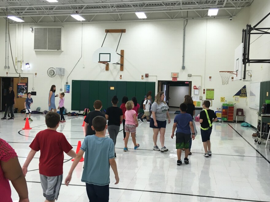 Oakland Elementary students run around the gym