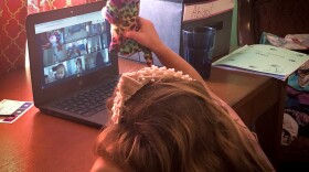 Five-year-old Abby Bucolo attends her kindergarten classes online, weeks after the Almeda Fire destroyed her home.