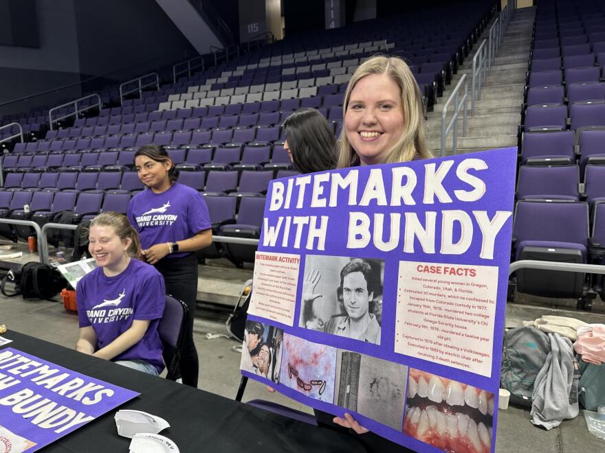 a female blonde white student holds up a poster about bite mark analysis