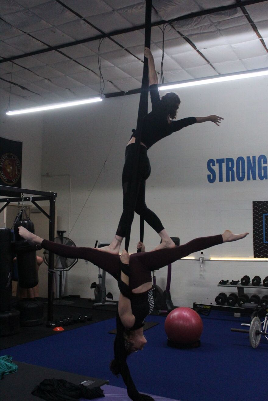 Kayla Forte (top) and Sarah Waitekus practice partner routines at Fit to Fly.