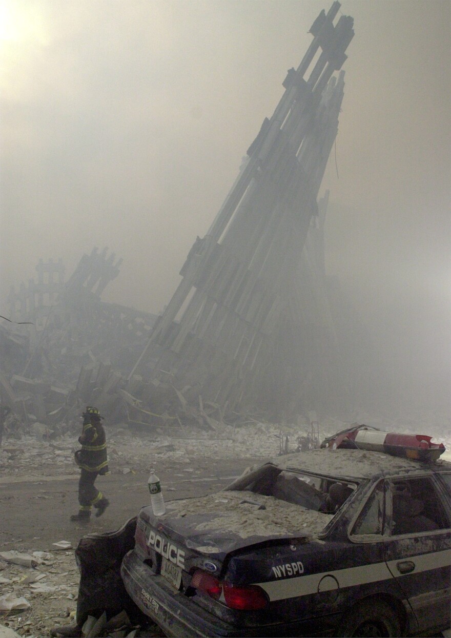 Destroyed mullions, the vertical struts which once faced the soaring outer walls of the World Trade Center towers, are the only thing left standing behind a lone fireman, after a terrorist attack on the twin towers of lower Manhattan Tuesday, Sept. 11, 2001. In an unprecedented show of terrorist horror, the 110-story towers collapsed in a shower of rubble and dust after two hijacked airliners carrying scores of passengers slammed into the sides of the twin symbols of American capitalism.